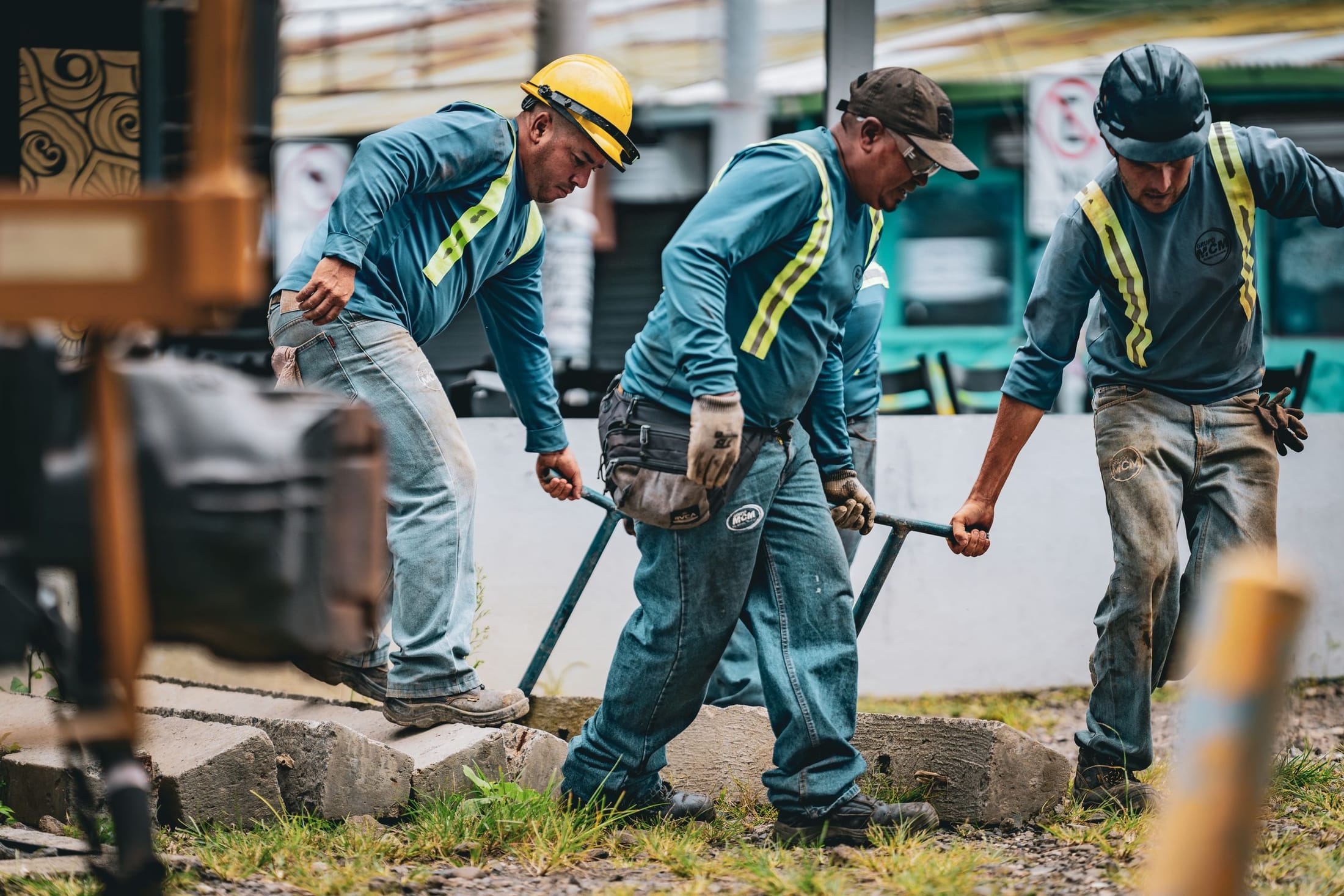 Site crew in hard hats and high-visibility clothing at work outdoors
