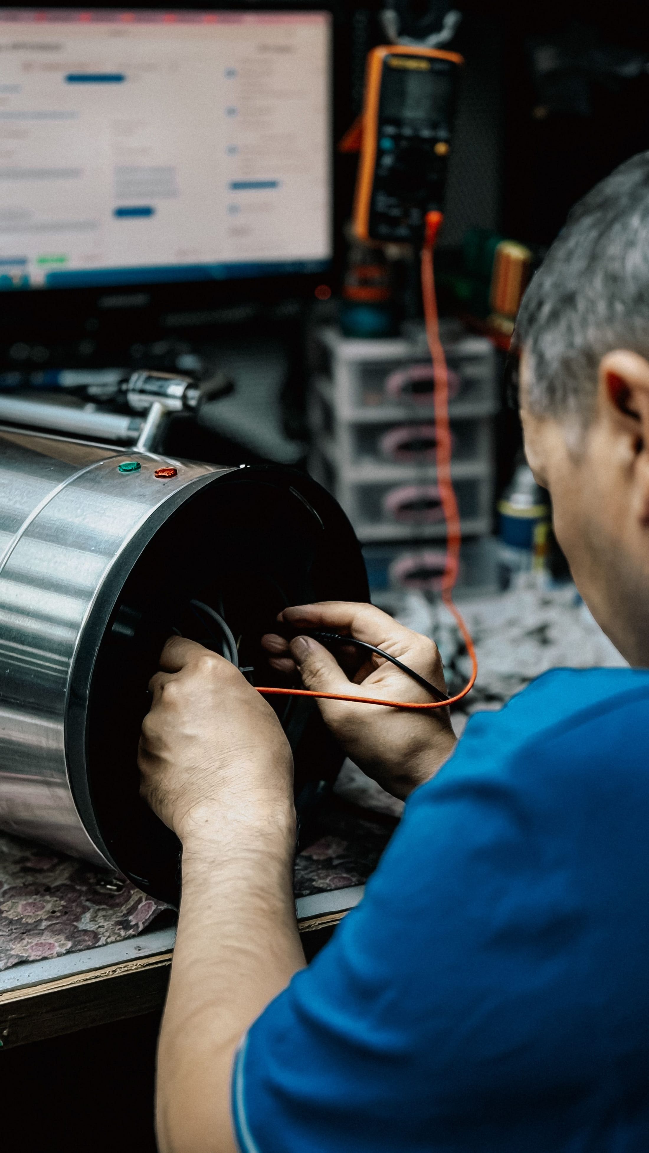 Technician working on the internals of a machine during maintenance