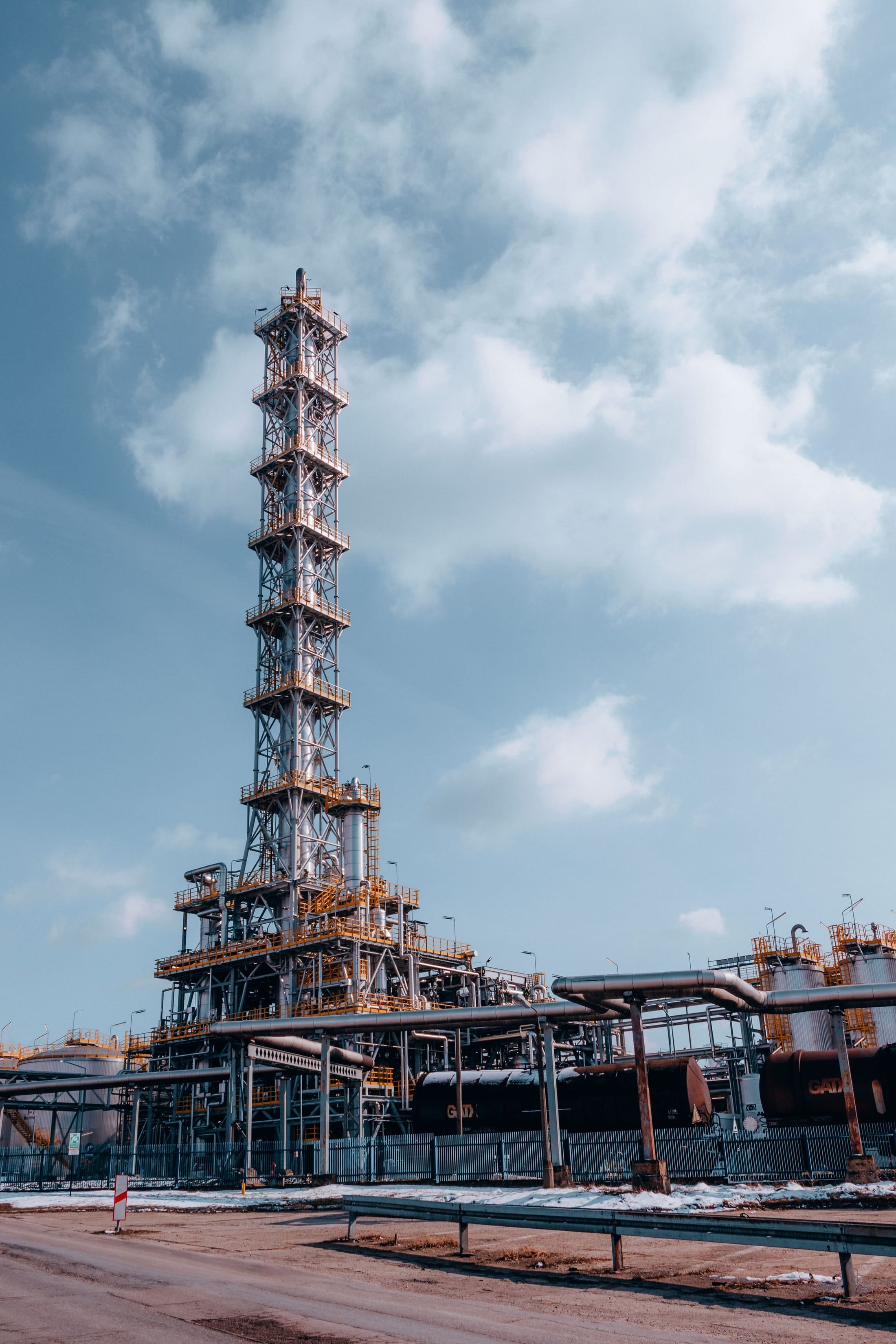 Process tower and flare structure against the sky