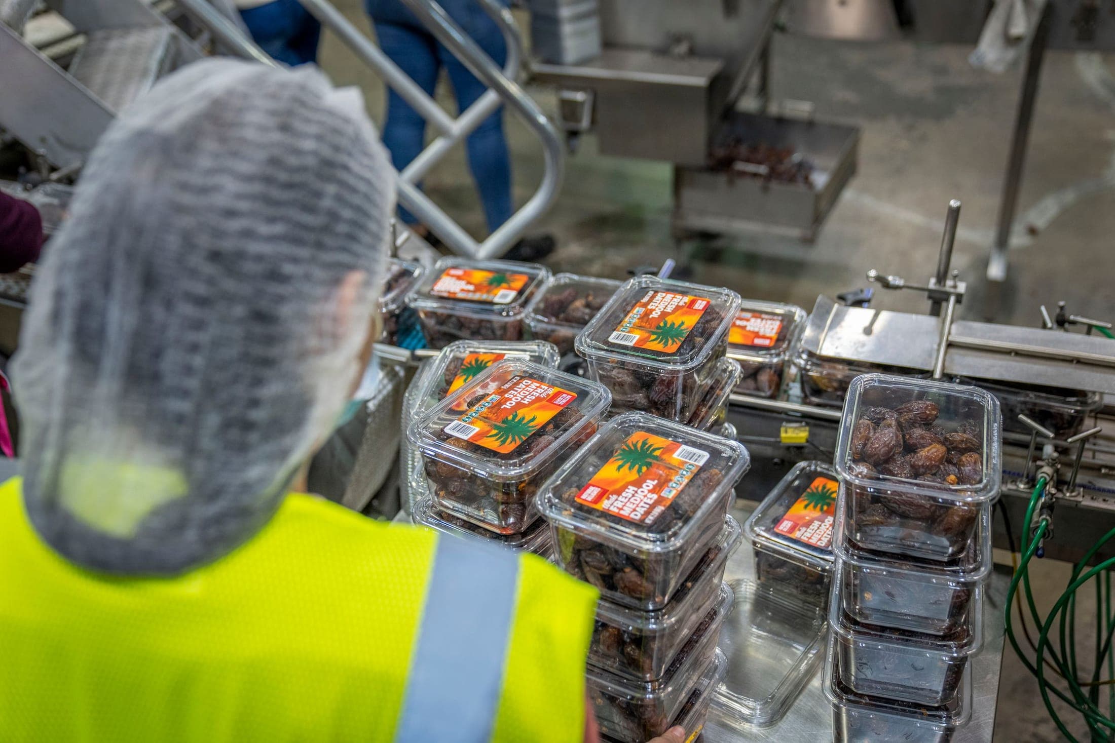 Operator in hygienic clothing at a packaging line