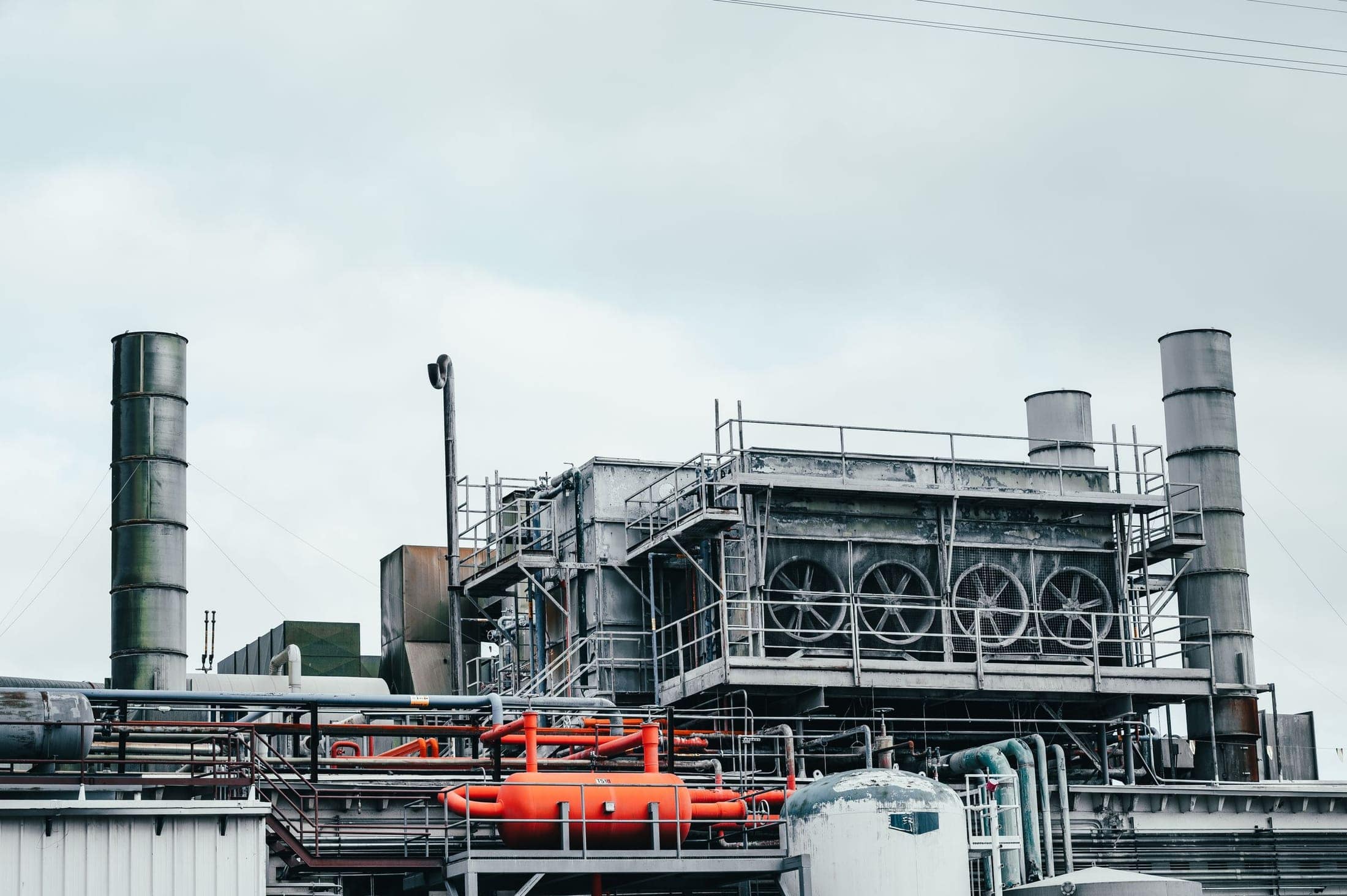 Industrial facility with stacks, pipework and access structures