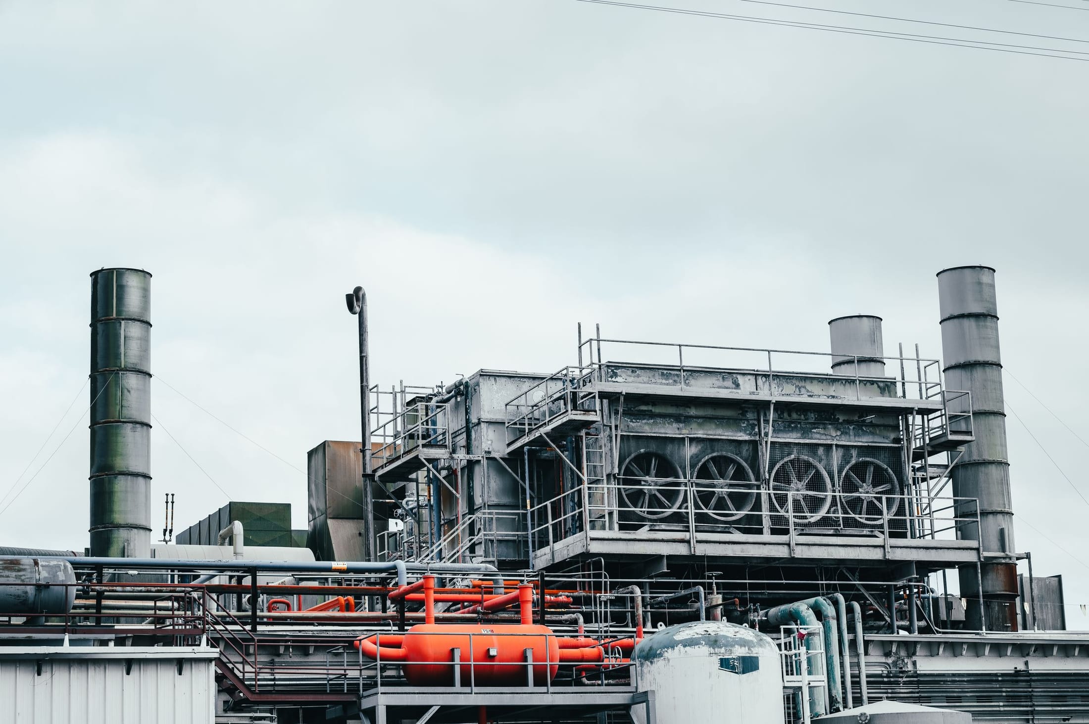 Industrial facility with stacks, pipework and access structures