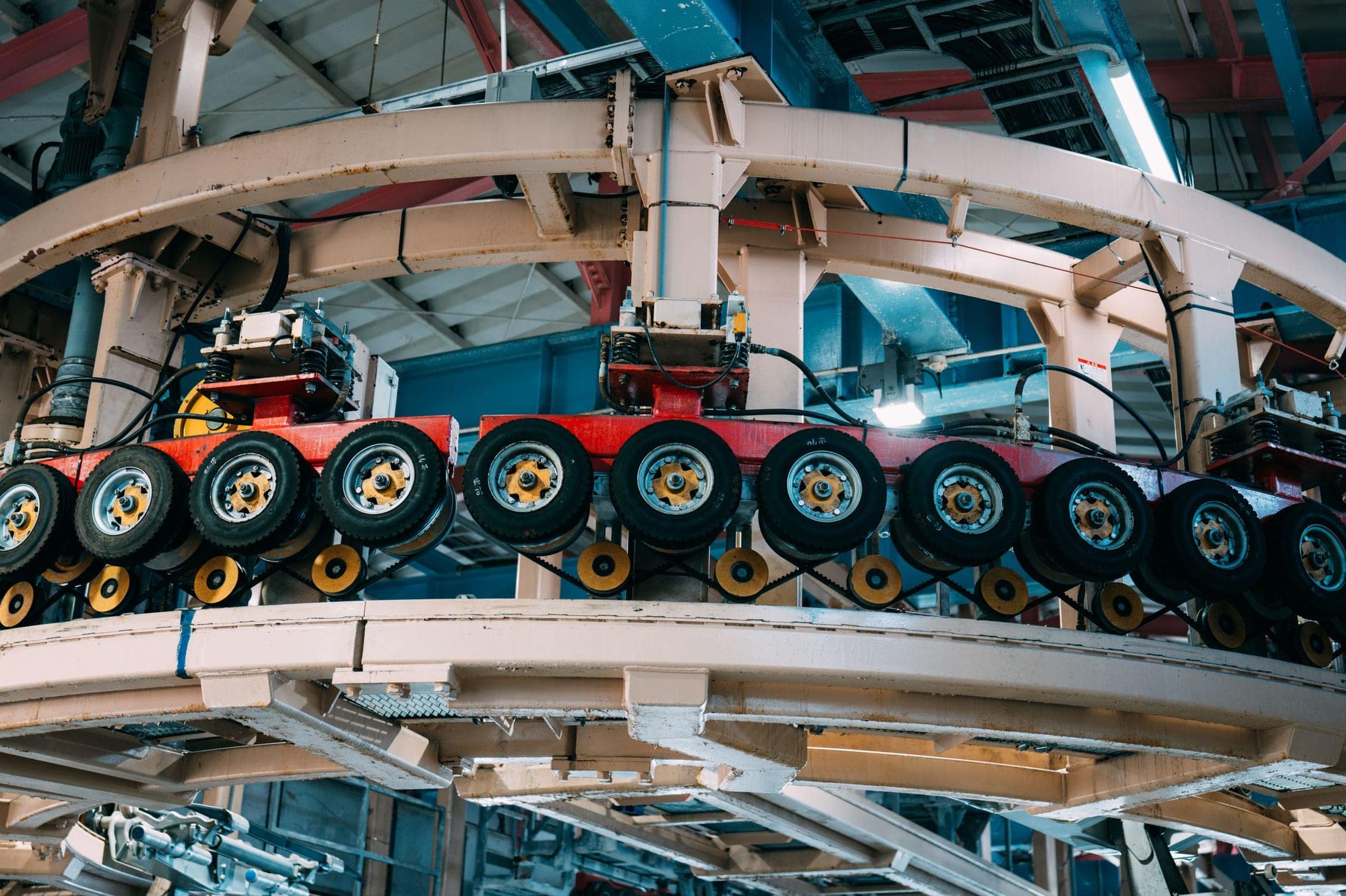 Large industrial machine with roller assemblies inside a production hall
