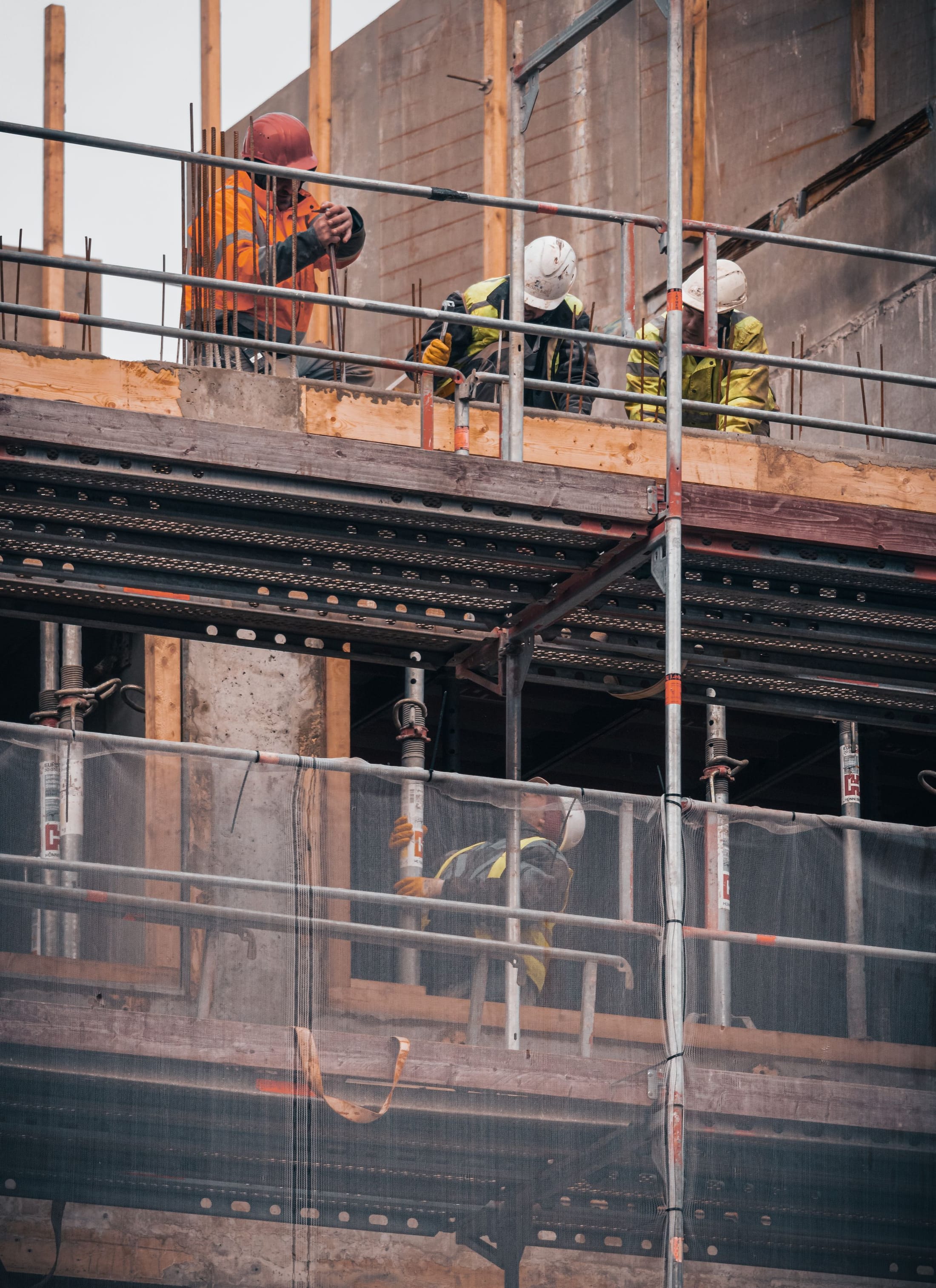 Worker on a scaffolded structure during construction works
